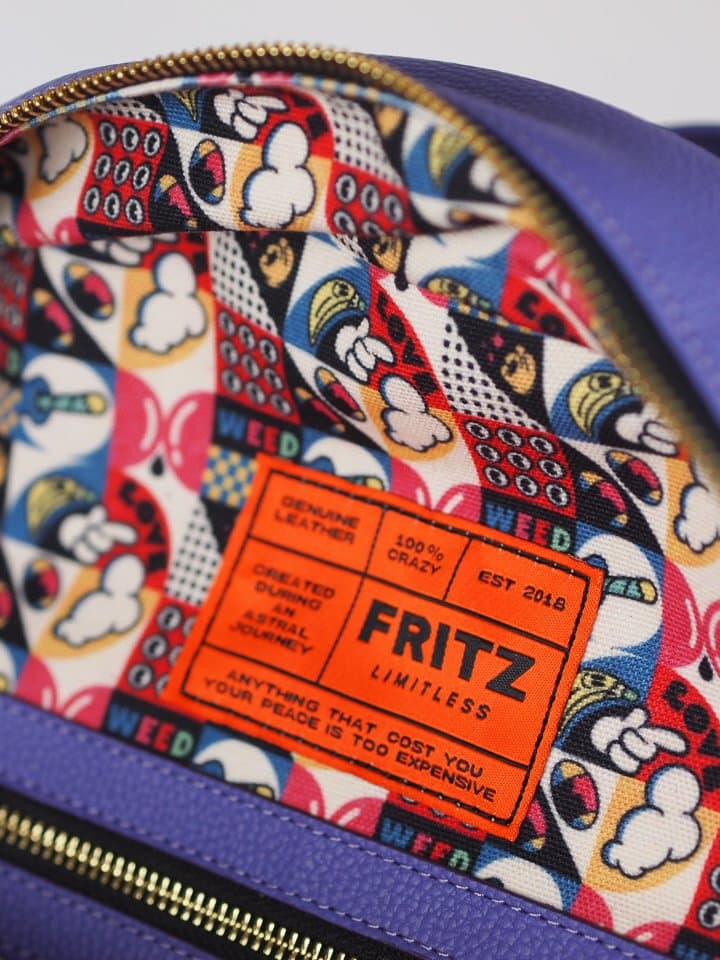 Interior lining of a backpack in comic print with the leather brand label