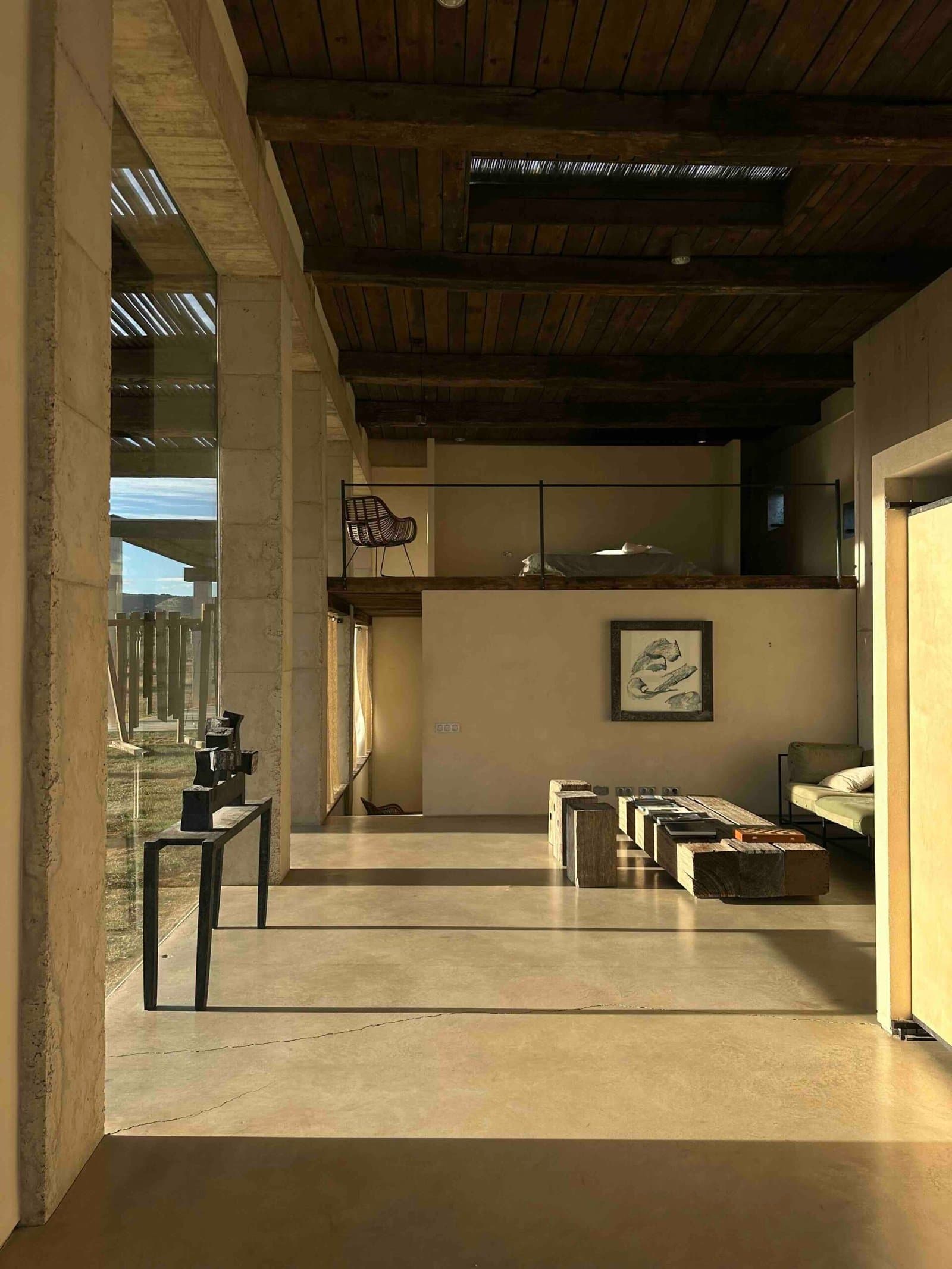 Interior passage with concrete columns leading to the living room
