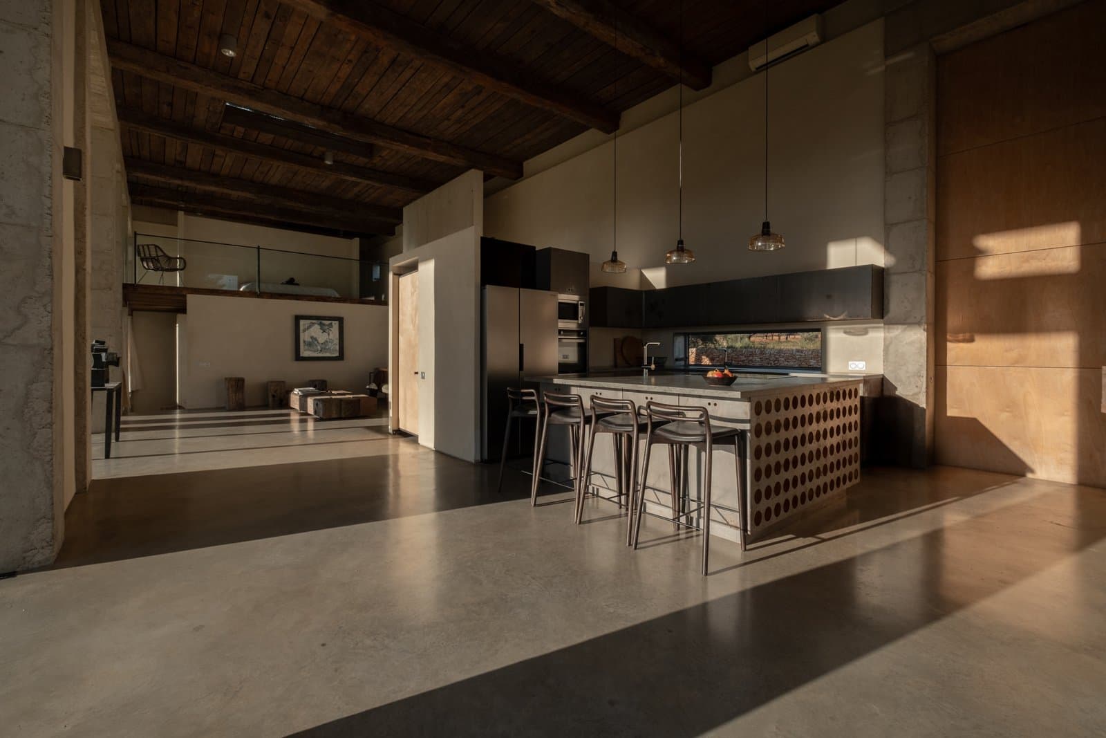 Open kitchen with a beamed ceiling and a large island